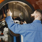 mechanic with tool wheel hands mechanic blue work clothes 1157 46154 1