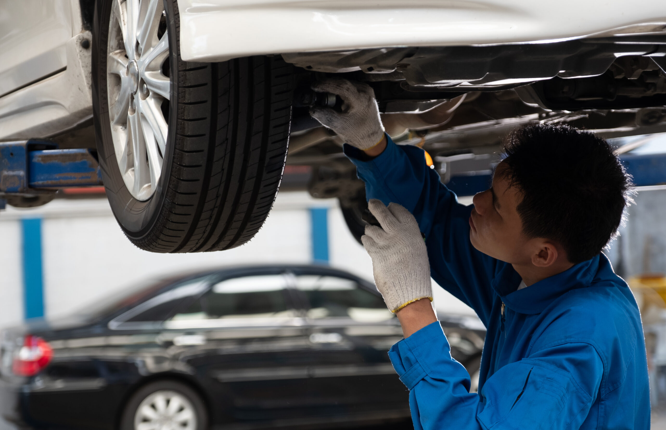 suspension noise repair in Brooklyn NY mechanic checking car suspension