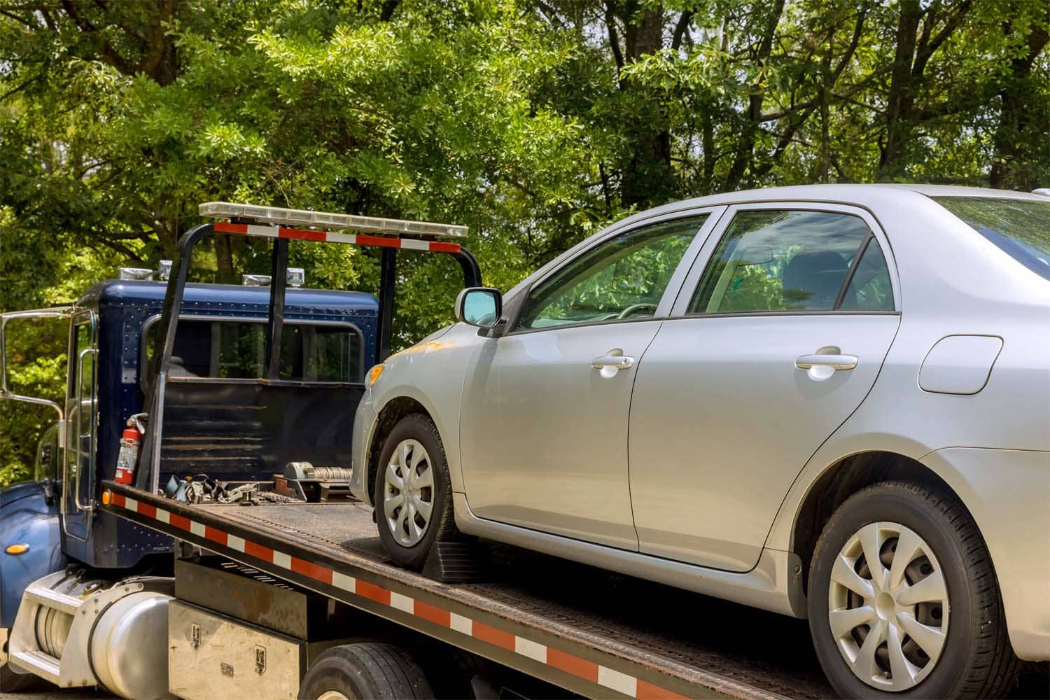 Tow truck assisting car on city street – Towing Service Brooklyn NY