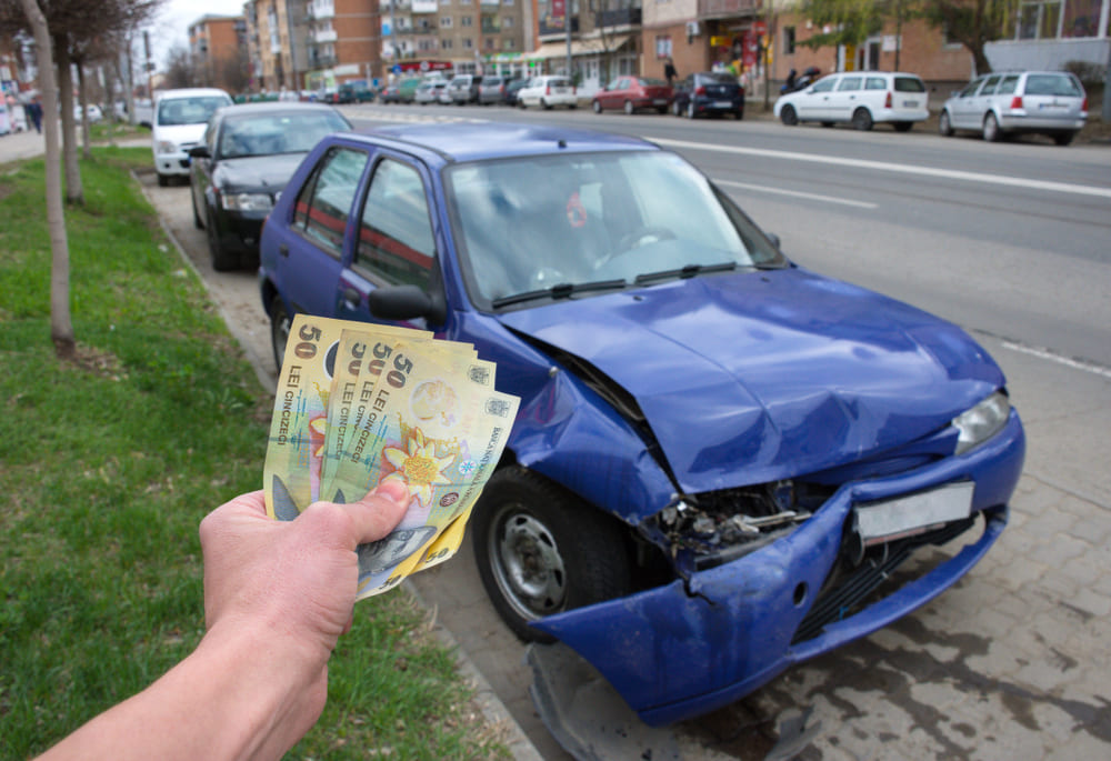 Mechanic inspecting auto body repair cost without insurance on a damaged vehicle in Brooklyn NY
