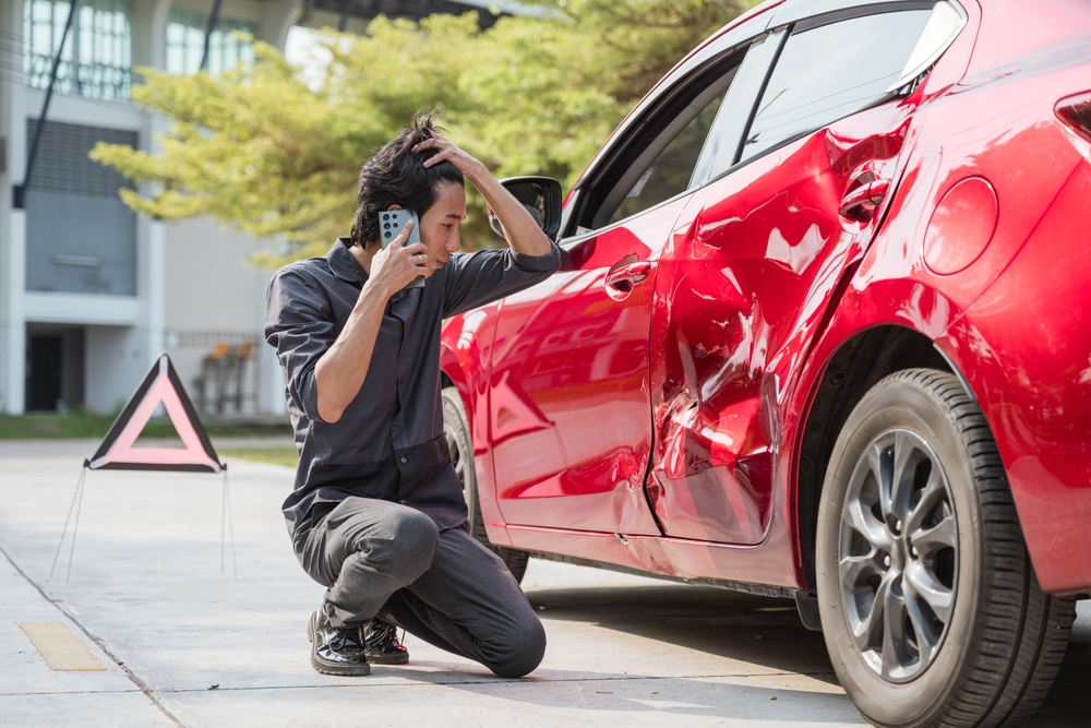 Types of collision damage that require auto body repair shown on a damaged vehicle exterior
