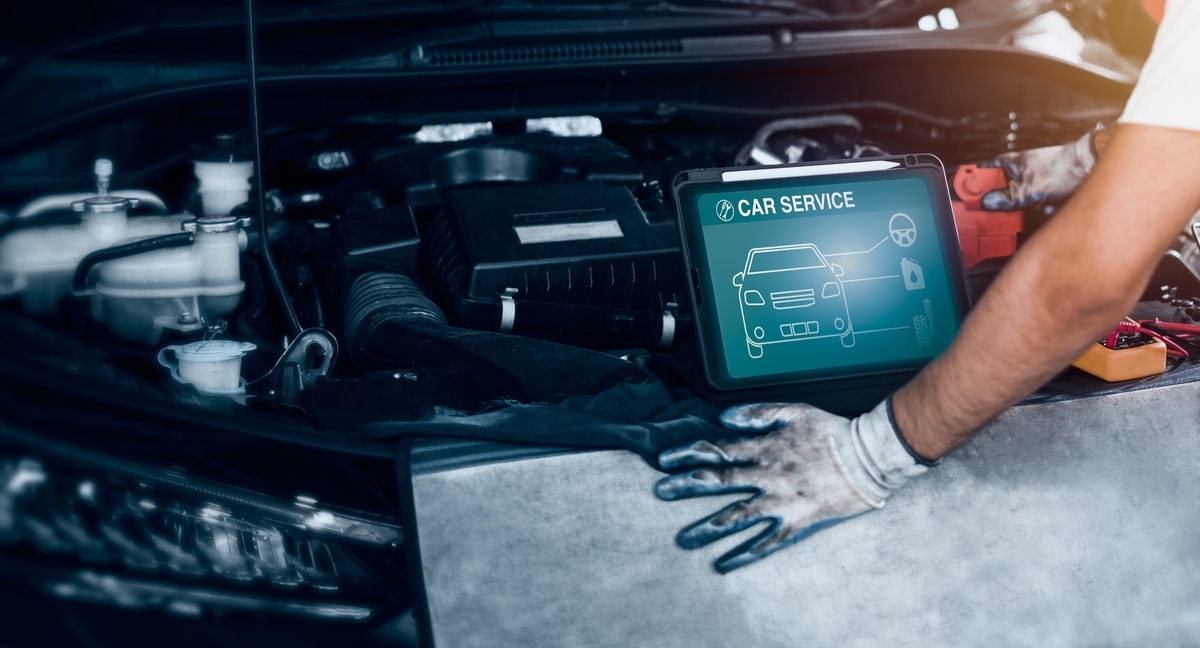 Collision Repair Quality in Brooklyn: What Drivers Must Know 11 Technician using a diagnostic tablet to verify collision repair quality in Brooklyn during a post-repair inspection at Cyclone Collision Center